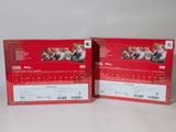 two red boxes with pictures of people on them sitting on a white surface