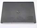 dell laptop computer with a black cover on a white surface