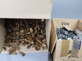two boxes with a bunch of metal items inside of them
