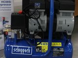 a blue air compressor sitting on the floor next to a sign