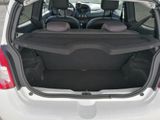 the back of a white car with its trunk open in a parking lot
