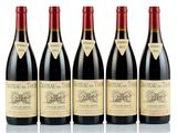 four bottles of red wine are lined up in a row