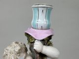 a figurine of a man holding a vase on his head
