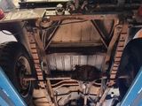 a car that is sitting on a lift in a garage