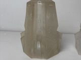 two vases that are sitting on a white surface
