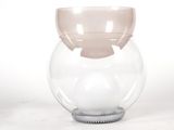 a glass vase that has a ball inside of it