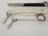 three different types of scissors and a pen on a white table