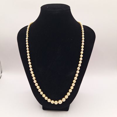 un collier de perles blanches sur un mannequin noir