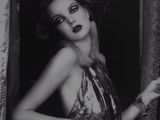 a black and white photo of a woman in a dress