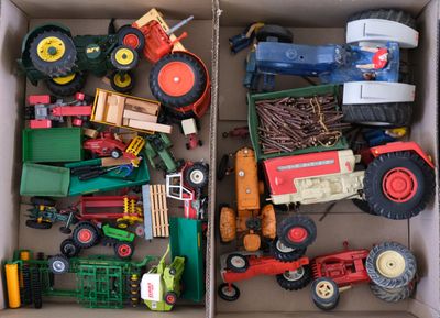 a box full of toy tractors and other toy vehicles