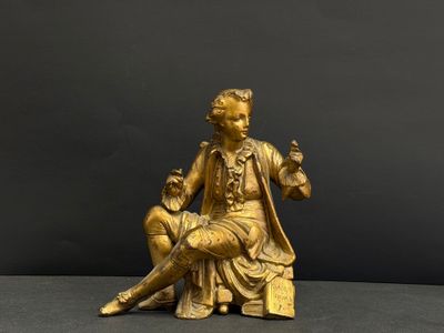statue en bronze représentant une femme assise sur un tabouret, avec un homme assis sur ses genoux