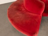 an image of a red chair in a room with concrete flooring