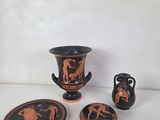 four pieces of pottery on a white surface