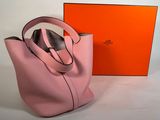 a pink hermeson bag with a box in the background
