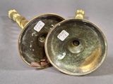 pair of antique brass candlesticks with labels on them