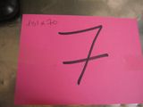 pink post it note with the letter f on it sitting on a table