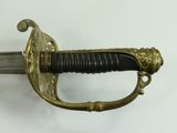 a close up of a sword on a white surface