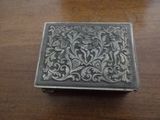 a silver box sitting on a wooden table