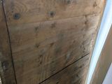 a wooden door that is open in a room