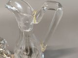 a glass pitcher sitting on top of a silver tray