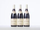 three bottles of wine sitting on top of a table next to each other