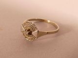 an image of a gold ring with a brown stone in it