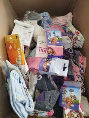 a cardboard box full of children ' s clothing and other items