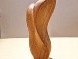 wooden sculpture of a woman ' s foot on a wooden stand
