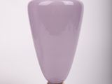 purple vase with gold trim on pedestal against white background