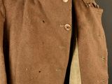 an image of a brown coat with buttons on a mannequin