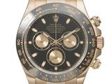 Montre Rolex avec cadran noir et lunette en or rose