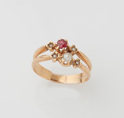 a close up of a gold ring with a pink stone and pearls