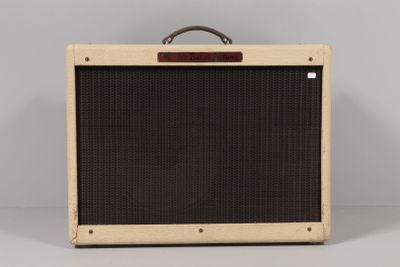a close up of a brown and black amplifier on a white surface