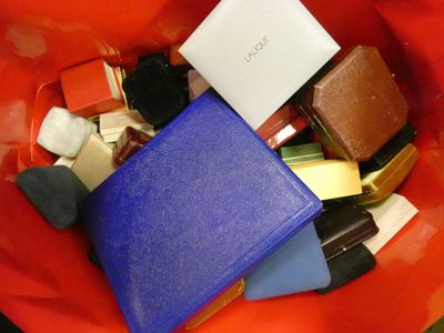 a red bowl filled with assorted items and a cell phone