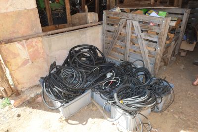 a pile of wires and other electrical equipment in a room