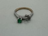 a silver ring with a green stone on it