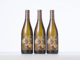three bottles of wine sitting on top of a table next to each other