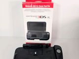 the nintendo 3ds is sitting on the table with its box open