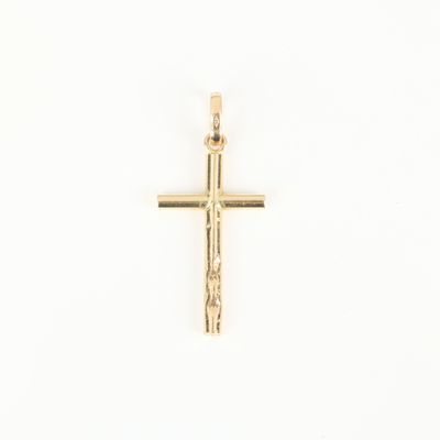 gold plated cross pendant with a crucift on a white background