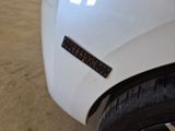 a sticker on the hood of a white car