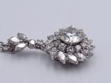 an image of a close up of a diamond pendant on a chain