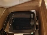 a cell phone sitting in a box on the floor