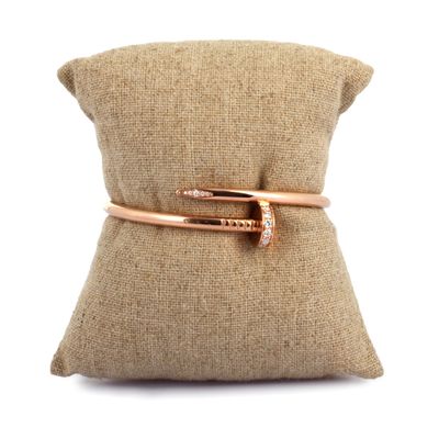 a close up of a pillow with a ring on top of it