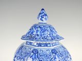a blue and white vase with an elephant on it