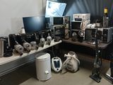 a lot of electronics on a table in a room