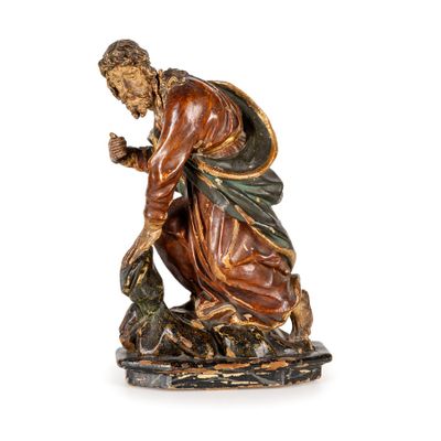 une image représentant une statue d'un homme à genoux, tenant un oiseau dans la main