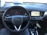 a picture of a man driving a car with the steering wheel down