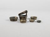 an image of a group of small metal objects on a white surface