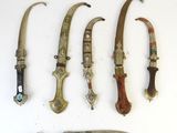 several different types of knives are displayed on a white surface