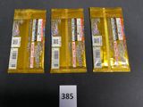 three packets of candy sitting on top of a table next to each other